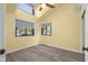 Bright bedroom featuring many windows, neutral paint, laminate flooring, and ceiling fan at 740 Carya Sq, Columbus, IN 47201