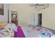 Vaulted bedroom features a colorful floral bedspread and access to the bathroom at 740 Carya Sq, Columbus, IN 47201
