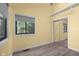 Bright bedroom featuring wood-look floors, a large window, and a mirrored closet at 740 Carya Sq, Columbus, IN 47201