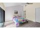 Bright bedroom features vaulted ceiling, fan, a colorful floral bedspread, and light-colored flooring at 740 Carya Sq, Columbus, IN 47201