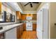 Bright kitchen features wood cabinets, hardwood floors, and modern white appliances at 740 Carya Sq, Columbus, IN 47201
