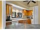 This cozy kitchen features wood cabinets, a white refrigerator, and a charming window view at 740 Carya Sq, Columbus, IN 47201