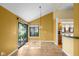 Open floor plan featuring tile floors, access to the yard, and a breakfast bar to the kitchen at 740 Carya Sq, Columbus, IN 47201