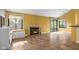 Spacious living room with a fireplace, window seat, and sliding glass doors to the backyard at 740 Carya Sq, Columbus, IN 47201