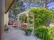 Relaxing outdoor patio with a cushioned swing, mature trees, and lush greenery at 740 Carya Sq, Columbus, IN 47201