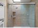 Tiled shower with glass doors, two corner shelves, and a rain shower head at 740 Carya Sq, Columbus, IN 47201