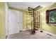 Staircase area with a winding wooden staircase, bright paint and laminate flooring at 740 Carya Sq, Columbus, IN 47201