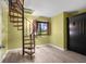 Bright stairwell with spiral staircase, shuttered window, and storage cabinet at 740 Carya Sq, Columbus, IN 47201