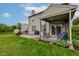 Cozy back patio with outdoor seating area, barbecue grill, and string lights at 7452 Lace Bark Ct, Avon, IN 46123