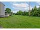 Expansive backyard with lush green grass, mature trees, and a patio area at 7452 Lace Bark Ct, Avon, IN 46123