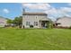 A spacious backyard with a grill, patio, a fire pit, and a partial wooden fence at 7452 Lace Bark Ct, Avon, IN 46123