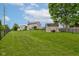 Spacious backyard featuring a large grassy area, storage shed, and mature tree at 7452 Lace Bark Ct, Avon, IN 46123