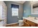 Bathroom featuring a shower/tub combination, wood vanity, and blue accent wall at 7452 Lace Bark Ct, Avon, IN 46123