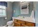Bathroom featuring a vanity with a sink, toilet, and blue accent wall at 7452 Lace Bark Ct, Avon, IN 46123