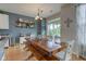 Dining area with a wooden table and a view of the backyard and shelving at 7452 Lace Bark Ct, Avon, IN 46123
