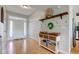 Inviting foyer with hardwood floors, white doors, and a decorative storage console with shelving at 7452 Lace Bark Ct, Avon, IN 46123