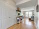 Open foyer with hardwood floors, a coat closet, and a glimpse into the adjacent living and dining areas at 7452 Lace Bark Ct, Avon, IN 46123