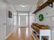Bright foyer with hardwood floors, a white front door, and decorative shelving with storage at 7452 Lace Bark Ct, Avon, IN 46123