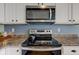 Modern kitchen features stainless steel microwave and oven with brown countertops at 7452 Lace Bark Ct, Avon, IN 46123