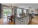 Open concept kitchen with a large island, dining area, and living space at 7452 Lace Bark Ct, Avon, IN 46123