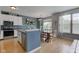 Modern kitchen with white cabinets, stainless steel appliances, and an island with seating at 7452 Lace Bark Ct, Avon, IN 46123