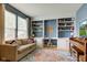 Cozy living room features built-in bookshelves, a comfortable sofa, and a colorful area rug at 7452 Lace Bark Ct, Avon, IN 46123