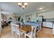 Open concept living, dining, and kitchen area with ample lighting and wooden floors at 7452 Lace Bark Ct, Avon, IN 46123