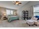 Spacious main bedroom with a ceiling fan, vaulted ceiling, and a sitting area by the windows at 7452 Lace Bark Ct, Avon, IN 46123