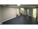 Spacious finished basement with painted brick wall, dark floors, and several entrances at 7514 Ruskin Pl, Indianapolis, IN 46226