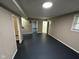 Spacious finished basement with painted brick wall, dark floors, and several entrances at 7514 Ruskin Pl, Indianapolis, IN 46226