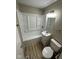 Bright bathroom features a shower-tub combo, a single sink vanity, and a toilet at 7514 Ruskin Pl, Indianapolis, IN 46226