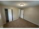Bedroom with neutral walls, carpet, and a closet at 7514 Ruskin Pl, Indianapolis, IN 46226