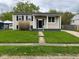 Traditional home boasts a neatly kept yard, inviting porch, and symmetrical design at 7514 Ruskin Pl, Indianapolis, IN 46226