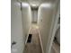 Long hallway with neutral colored walls and carpet leading to several rooms at 7514 Ruskin Pl, Indianapolis, IN 46226