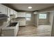 Efficient kitchen features bright white cabinets, countertop space, and modern vinyl flooring at 7514 Ruskin Pl, Indianapolis, IN 46226