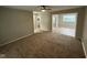 Open floor plan with neutral tones and carpet connecting the living area to other rooms at 7514 Ruskin Pl, Indianapolis, IN 46226