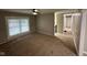 Living room featuring large windows, neutral walls and carpeted floors with easy access to hallway at 7514 Ruskin Pl, Indianapolis, IN 46226