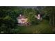 Aerial view of a luxurious home featuring a spacious backyard and wooded surroundings at 7624 William Penn Pl, Indianapolis, IN 46256