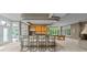 Basement bar area with a sleek counter, bar stools, and views of the adjacent recreation space at 7624 William Penn Pl, Indianapolis, IN 46256