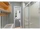 Bathroom area featuring shelving, shower and view to the exercise room with work out equipment at 7624 William Penn Pl, Indianapolis, IN 46256