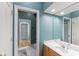 Well-lit bathroom with a spacious vanity, large mirror, and a glimpse into an adjoining area at 7624 William Penn Pl, Indianapolis, IN 46256