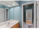 Bathroom showcasing a well-lit vanity with a large mirror reflecting the spacious and clean interior at 7624 William Penn Pl, Indianapolis, IN 46256