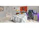Comfortable bedroom with neutral tones, featuring a well-lit desk area and a themed sports banner at 7624 William Penn Pl, Indianapolis, IN 46256