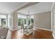 Sunlit dining area with large windows offers a serene view of the outdoor landscape at 7624 William Penn Pl, Indianapolis, IN 46256