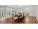 Formal dining area features wooden table with seating and multiple chandeliers at 7624 William Penn Pl, Indianapolis, IN 46256