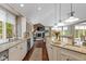 Spacious kitchen featuring a fireplace, large island, and built-in appliances at 7624 William Penn Pl, Indianapolis, IN 46256