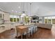 Open kitchen with a large island, wooden floors, and modern appliances at 7624 William Penn Pl, Indianapolis, IN 46256