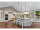 Well-lit kitchen with white cabinets, granite countertops, and hardwood floors at 7624 William Penn Pl, Indianapolis, IN 46256