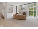 Open living room with large windows, fireplace, and modern staircase at 7624 William Penn Pl, Indianapolis, IN 46256