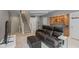 Comfortable living room with a leather sofa, stairs, and built-in shelving at 7624 William Penn Pl, Indianapolis, IN 46256